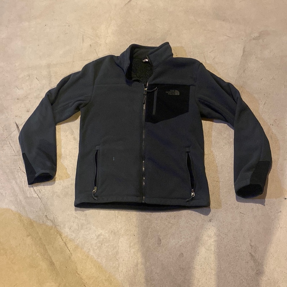 grey and black north face zip up